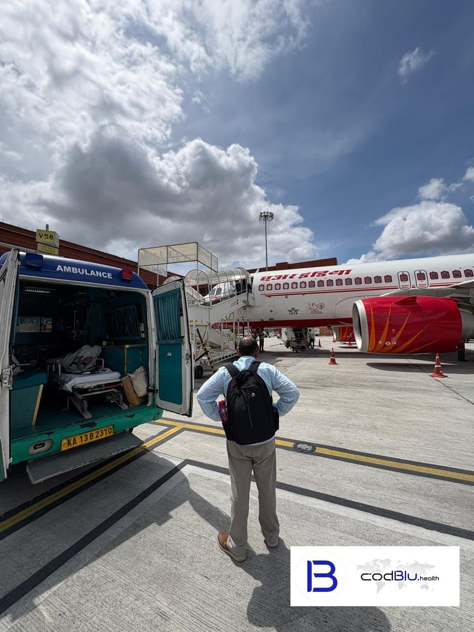 Ground ambulance meeting a commercial flight for a stretcher patient transfer at Bengaluru airport