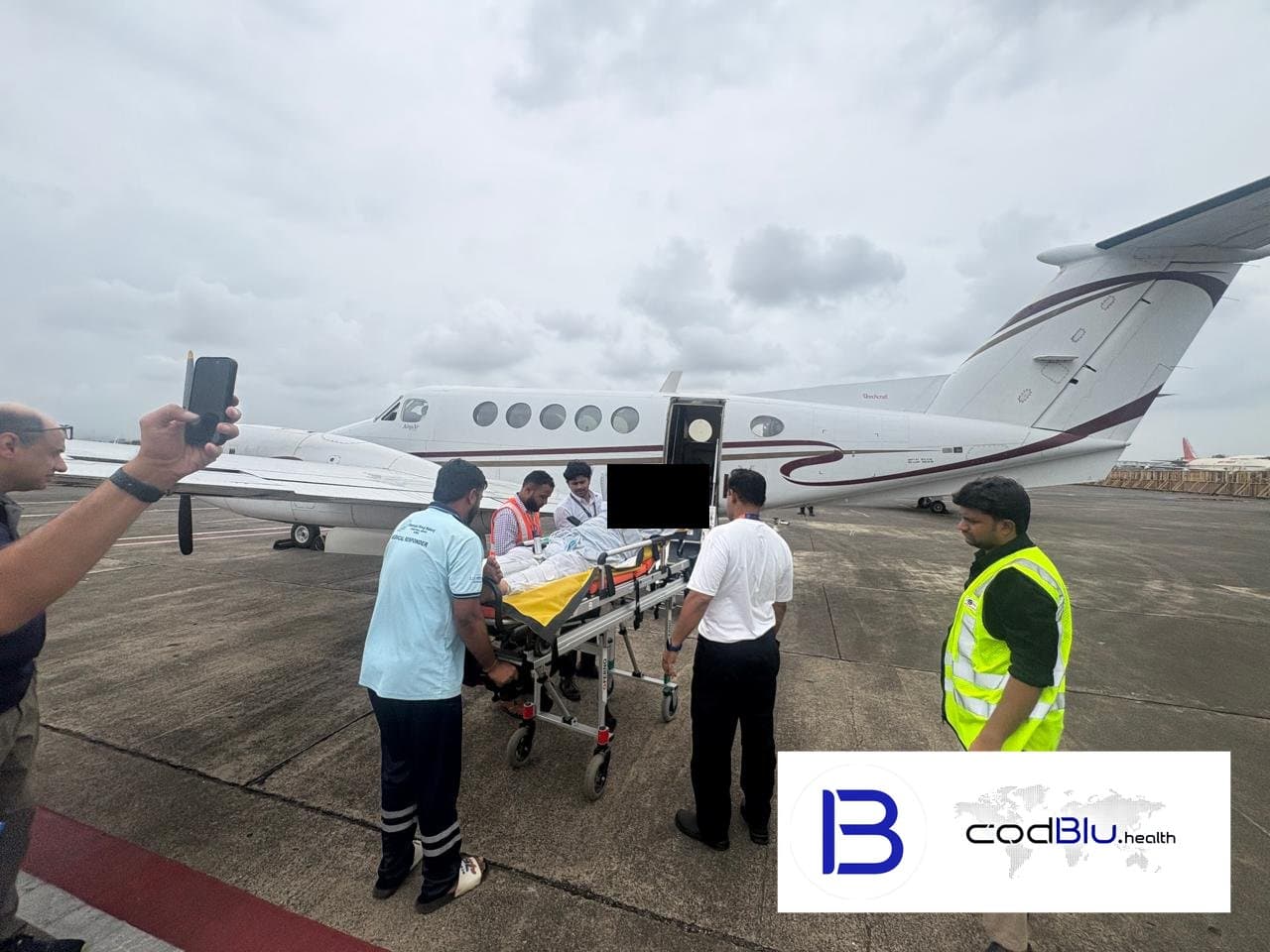 Bed-to-bed air ambulance transfer: stretcher patient loaded into a charter aircraft