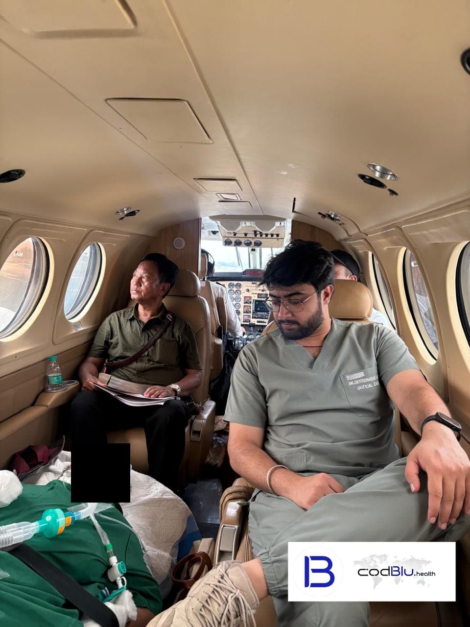 Critical care doctor with a ventilated patient on board an air ambulance