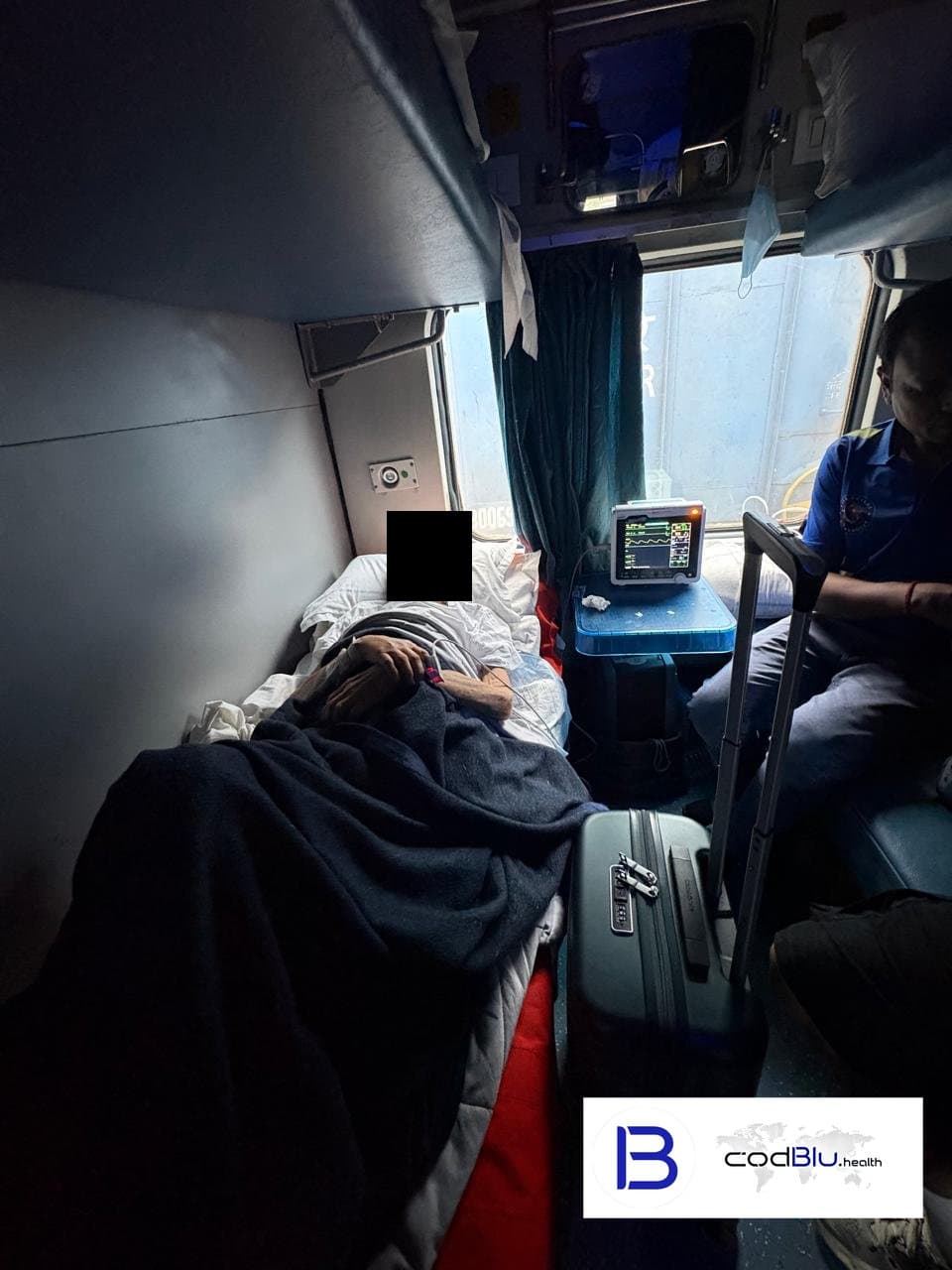 Bedridden patient transferred into a Second AC coach by the rail ambulance team